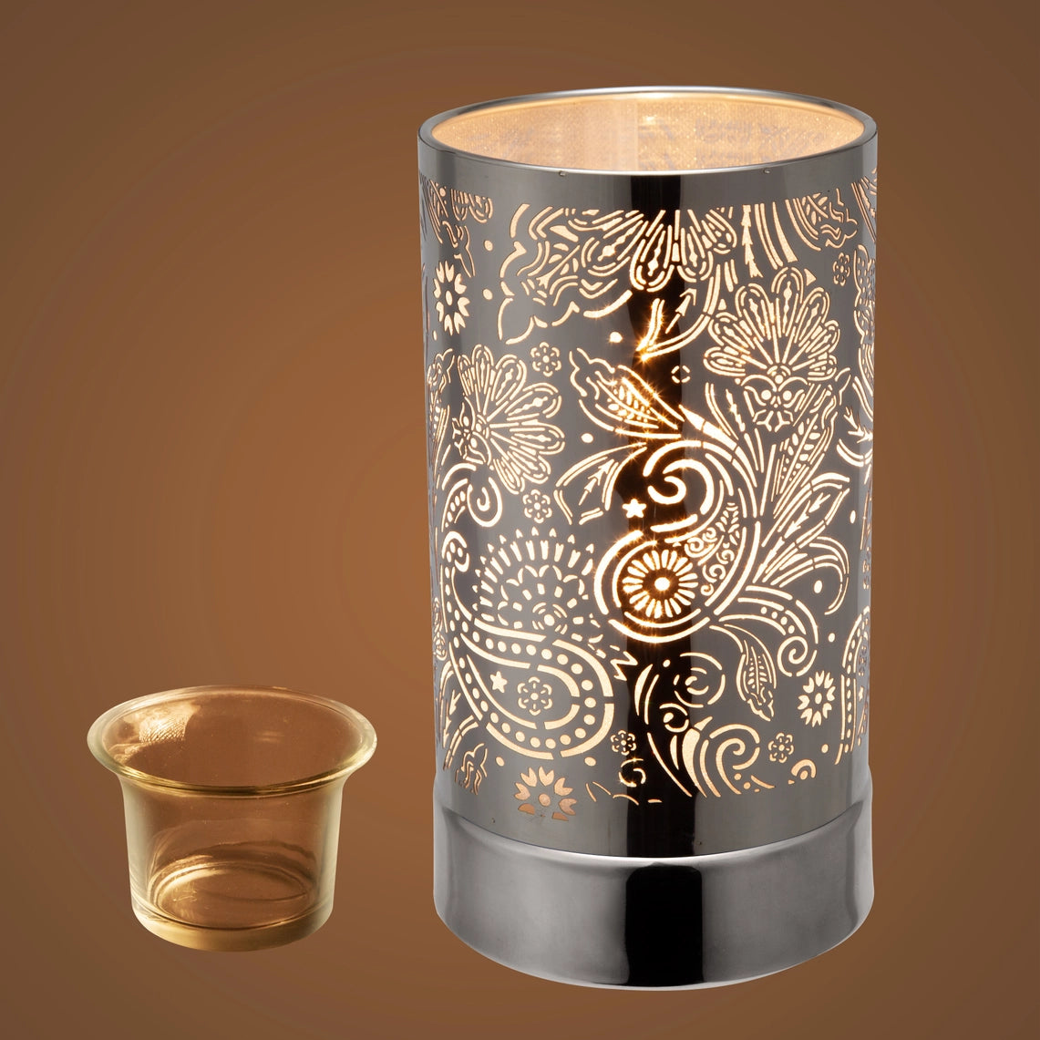 Decorative candle holder with floral patterns on a brown background